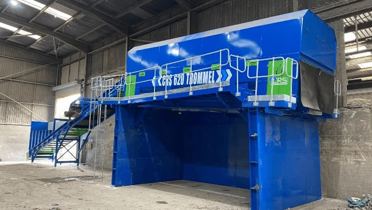 Heavy-duty trommel screen separating mixed recyclables and waste materials in a recycling plant